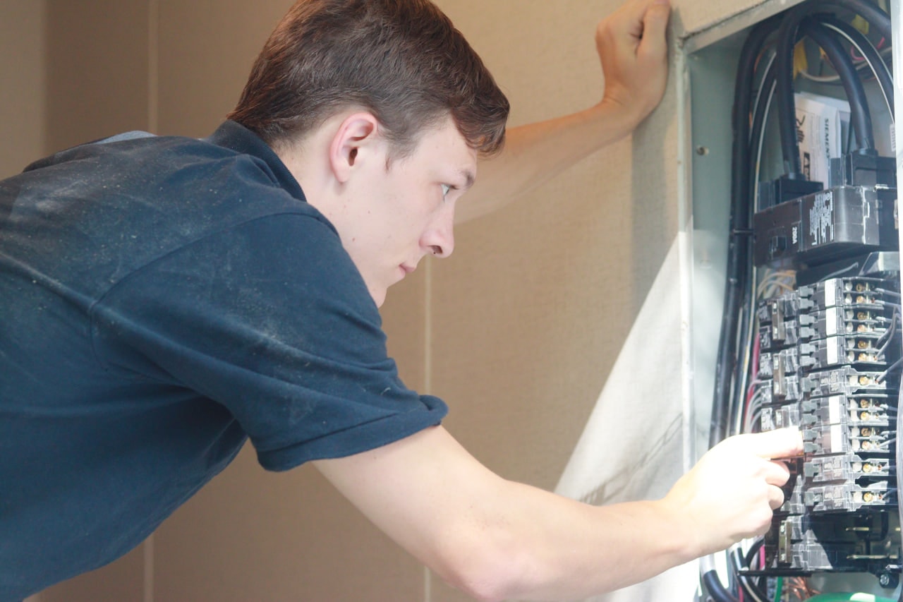 Phillip McClain inspecting electrical panel